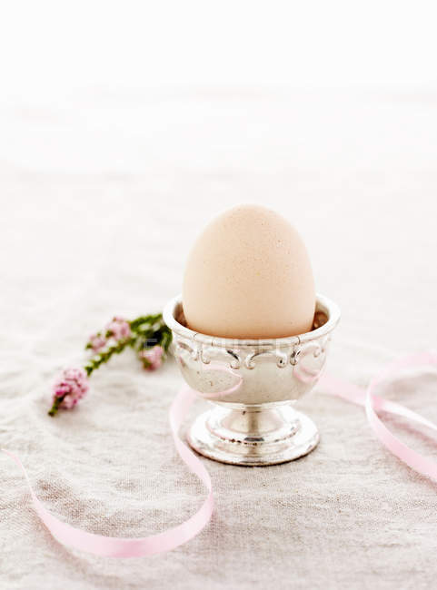 Egg in silver egg cup — Stock Photo