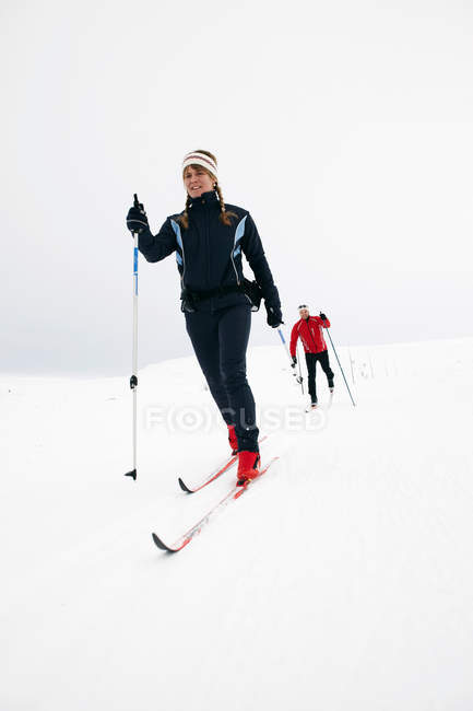 Couple cross country skiing in snow at winter — Stock Photo