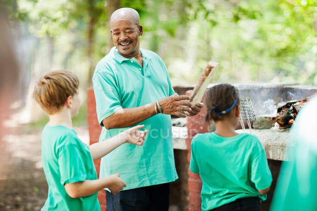 Students playing outside with teacher — Stock Photo