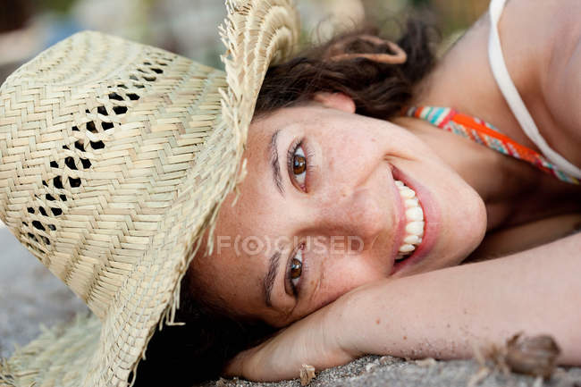Primo piano della donna sorridente che indossa il cappello da sole — Foto stock