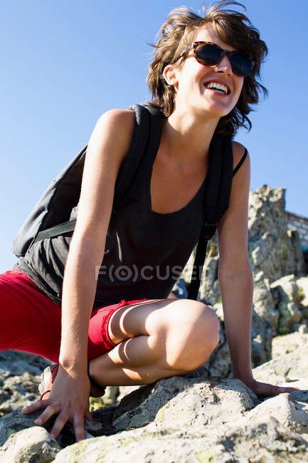 Hiker resting on rocks, focus on foreground — Stock Photo