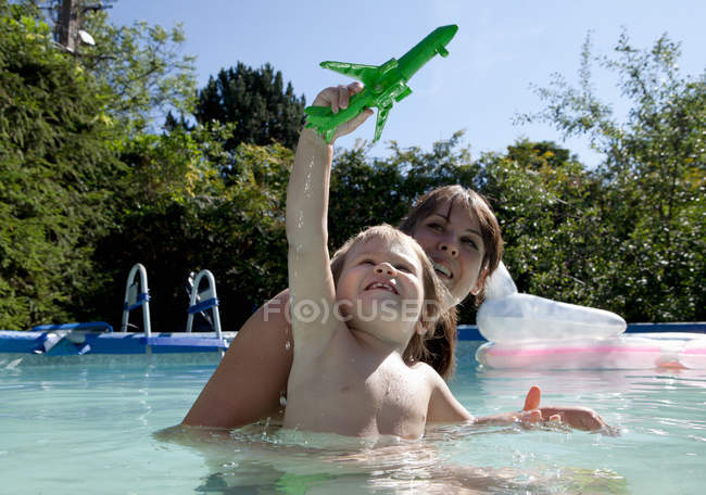 Mãe e filho brincando na piscina — Fotografia de Stock