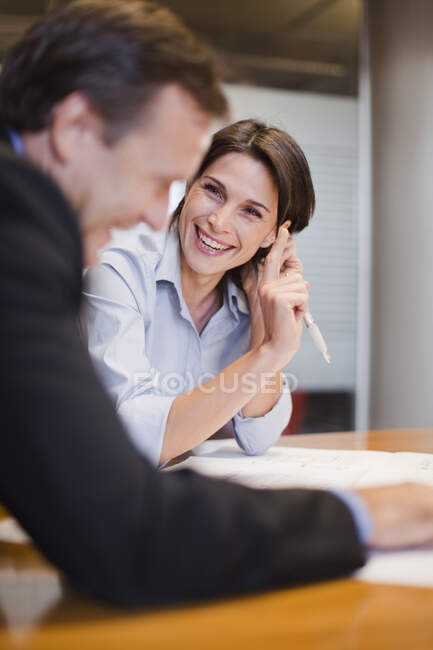 Business people laughing in office — Stock Photo