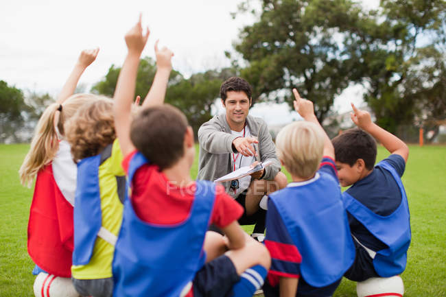 Children raising hands during practice — Stock Photo