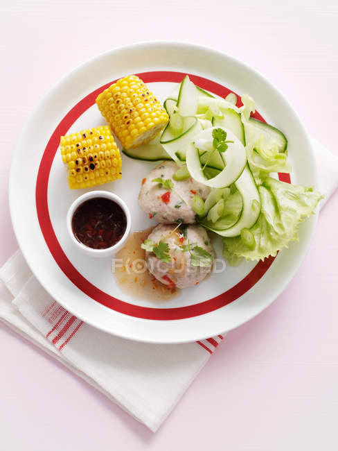Corn with cucumber salad — Stock Photo