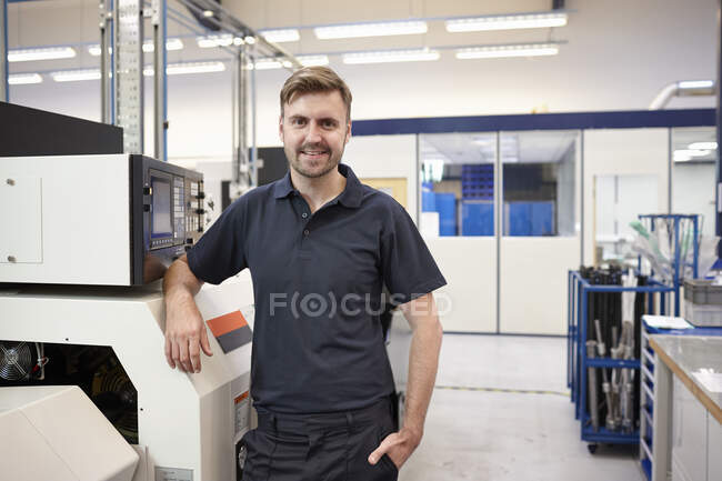 Portrait of engineer and equipment in engineering factory — Stock Photo