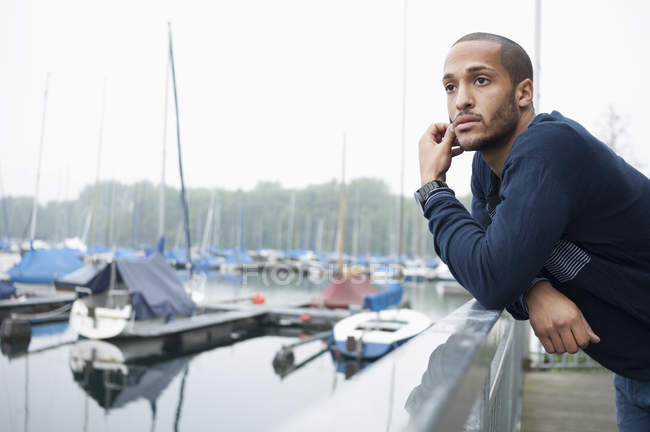 Portrait of young man in marina — Stock Photo