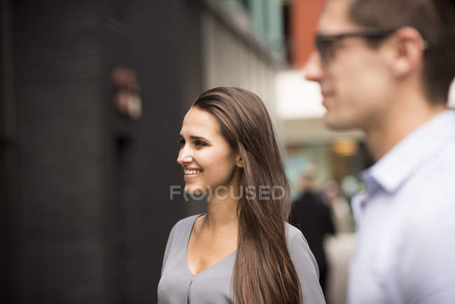 Young businessman and woman on street, London, UK — Stock Photo