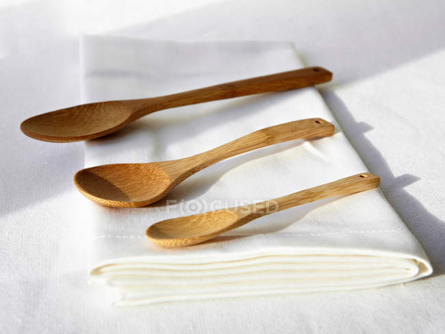 Wooden spoons on napkin — Stock Photo