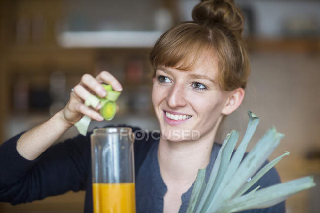 Mujer joven haciendo batido - foto de stock