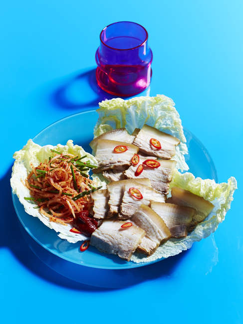 Braised pork belly slices in cabbage leaves — Stock Photo
