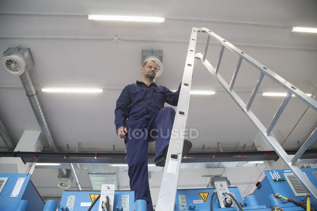 Мужской рабочий проверяет кабели на промышленном предприятии — стоковое фото
