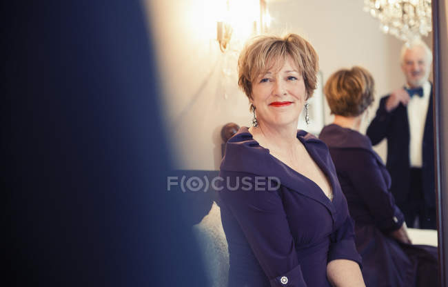 Mature woman smiling at husband in mirror — Stock Photo