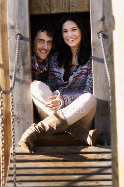 Couple in hut in playground — Stock Photo