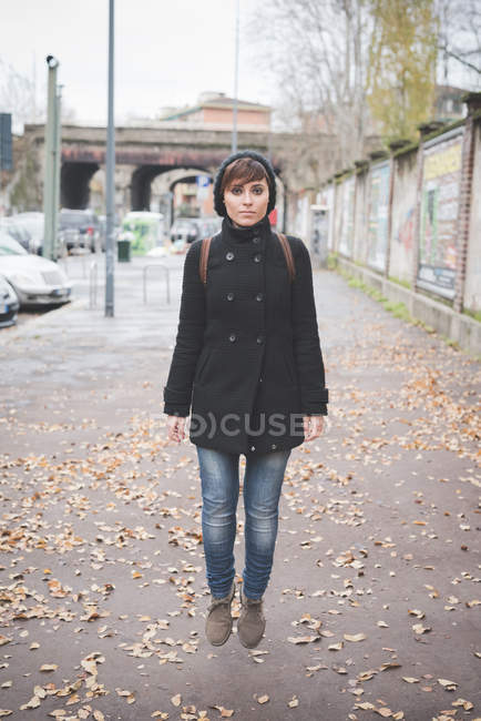 Young woman jumping on street — Stock Photo