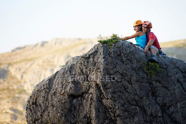 Coppia di arrampicatori seduti sulla roccia — Foto stock