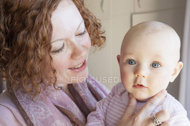 Portrait baby girl and mid adult mother at home — Stock Photo