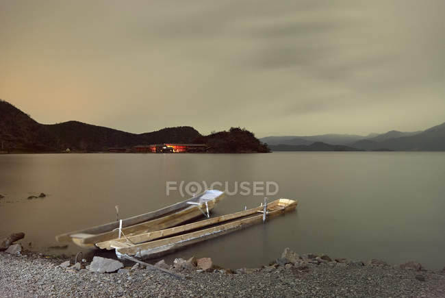 Two fishing boats moored on lakeside — Stock Photo