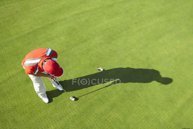 Vista alta del golfista y sombra de poner - foto de stock