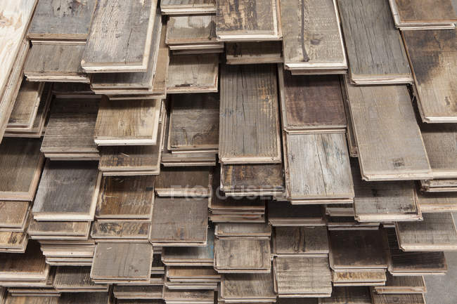 Stacks of treated wood flooring in factory — Stock Photo