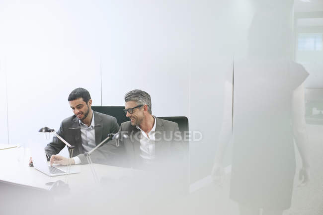 Male business colleagues using digital tablet in office — Stock Photo