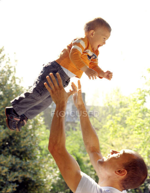 Father throwing son in the air — Stock Photo