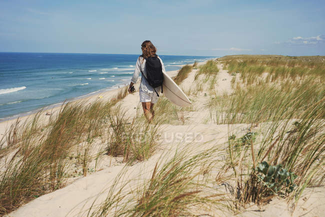 Woman with surfboard on beach, Lacanau, France — Stock Photo