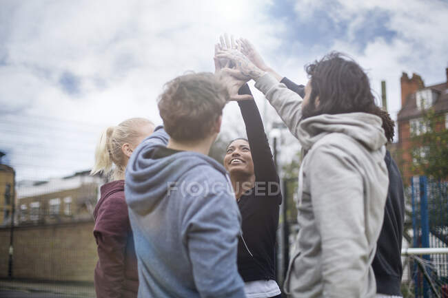 Group of adults, touching hands, outdoors — Stock Photo