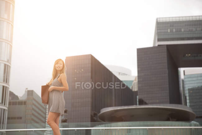 Jovem mulher caminhando ao lado do porto, Hong Kong, China — Fotografia de Stock