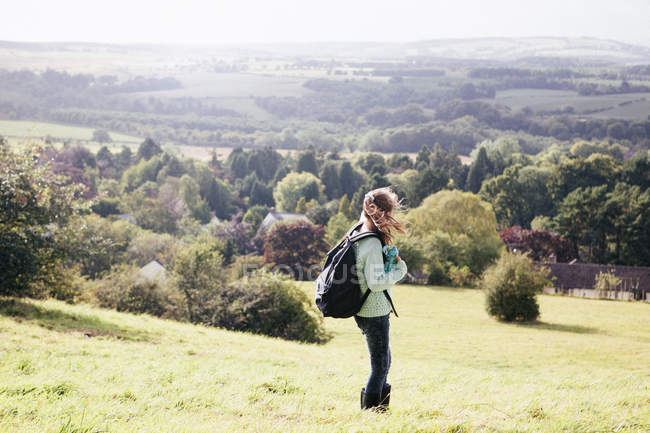 Girl standing in field looking at view — Stock Photo