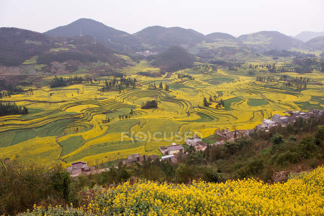 View of village and field terraces in valley — Stock Photo
