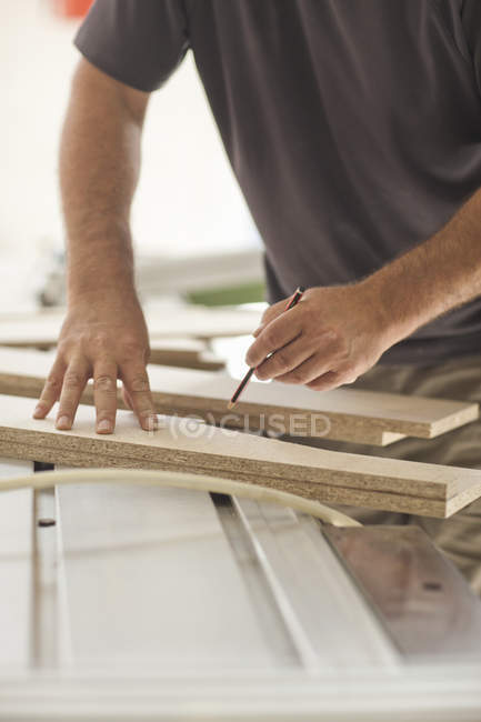 Upholsterer measuring planks of wood chip, cropped shot — Stock Photo