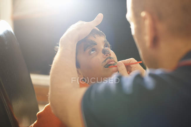 Father painting son lips for Halloween — Stock Photo