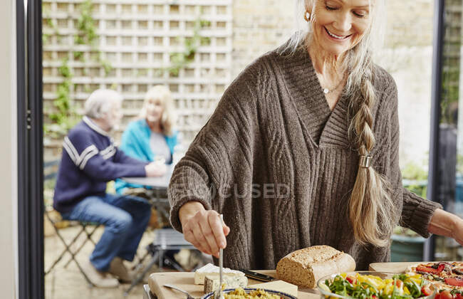 Seniorin bereitet Essen zu — Stockfoto