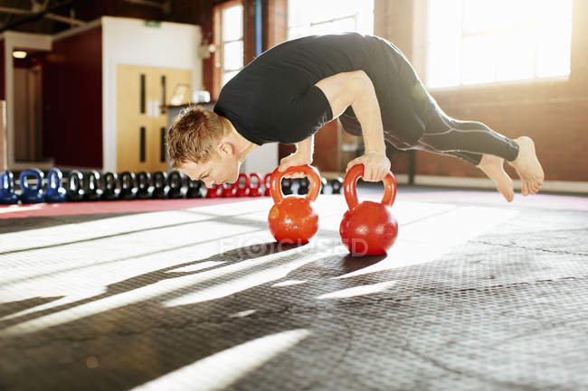 Man strength training with kettle bells — Stock Photo