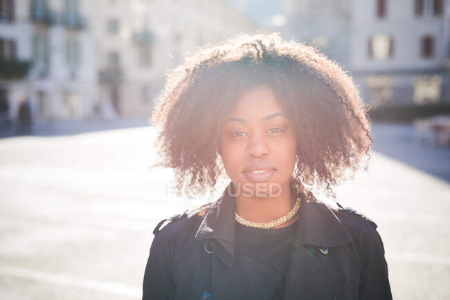 Portrait of stylish young woman in town square — Stock Photo