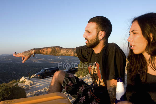 Young couple pointing and looking out to sea, Marseille, France — Stock Photo
