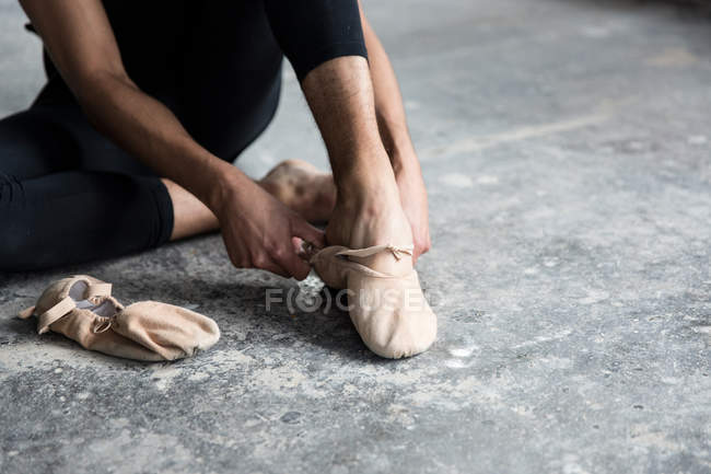 Danseuse portant une chaussure de ballet en studio — Photo de stock