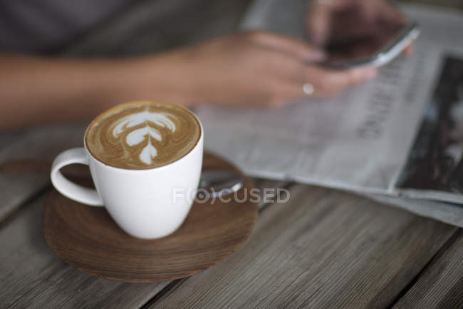 Close up of young woman using cellphone in cafe — Stock Photo