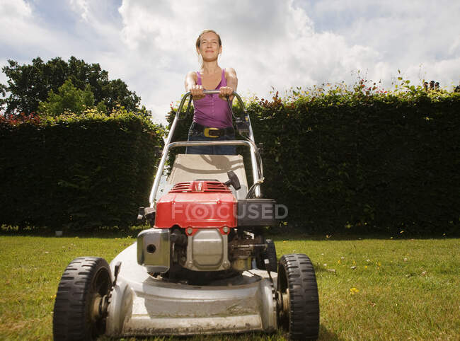 Women with push lawnmower — Stock Photo