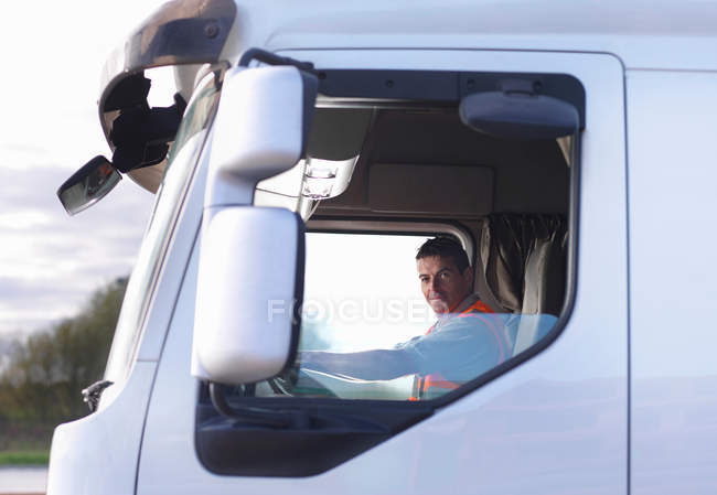 Truck driver in cab — Stock Photo