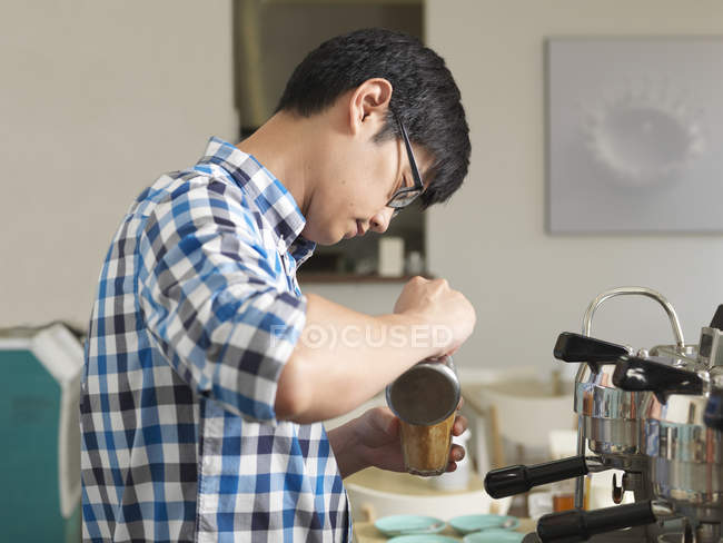 Man working behind coffee bar — Stock Photo