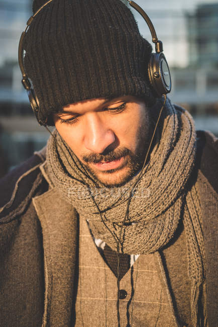 Portrait of stylish man listening music with headphones — Stock Photo