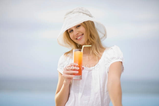 Girl having a drink outdoors — Stock Photo
