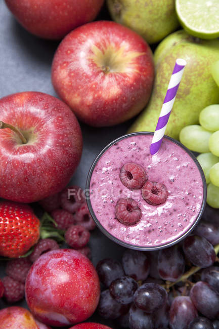 Still life of fresh fruit and raspberry smoothie — Stock Photo