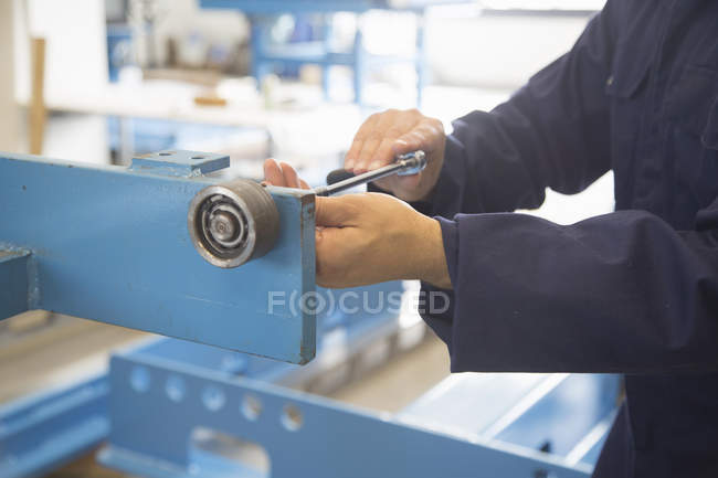 Worker hands using forcer at factoty — Stock Photo