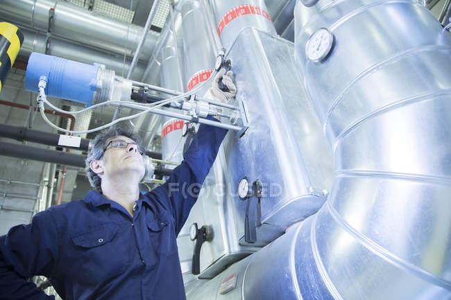 Engineer adjusting valve in power station — Stock Photo