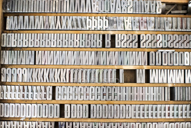 Shelves of silver letterpress letters — Stock Photo