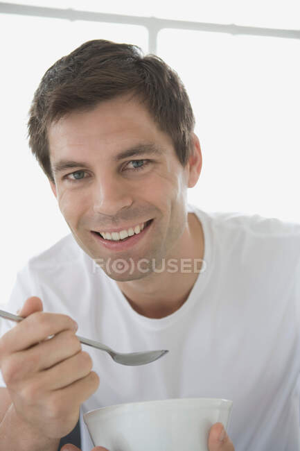 Portrait of a man holding a bowl. — Stock Photo