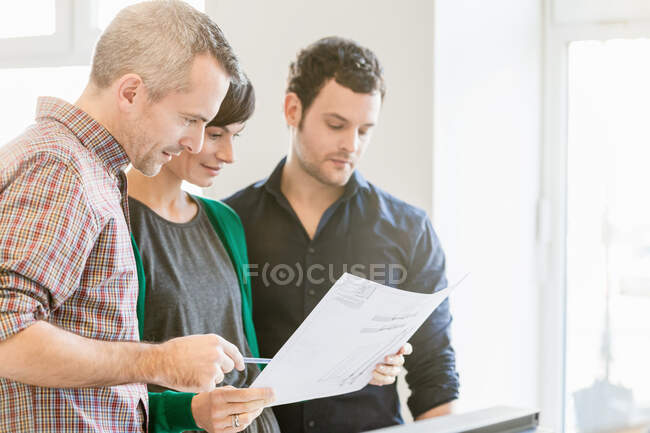 Colleagues looking at paperwork — Stock Photo